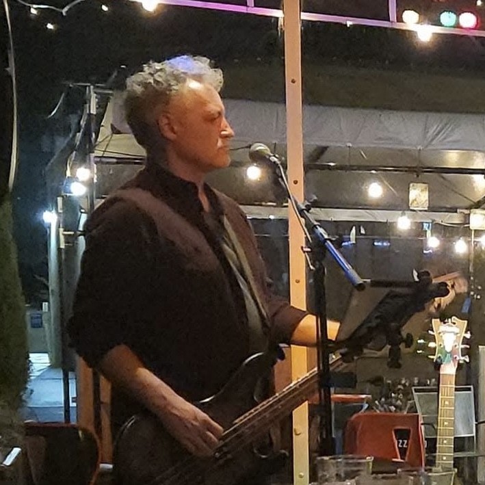 Andy Stober performing with bass guitar